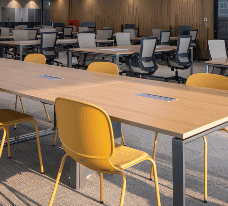 People working comfortably on office stools in a collaborative space
