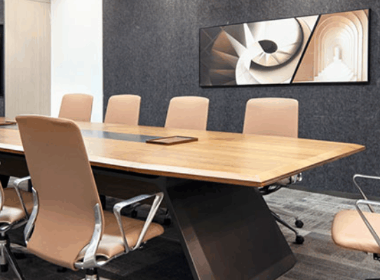 Professional shaking hands over a new office desk in a collaborative setting